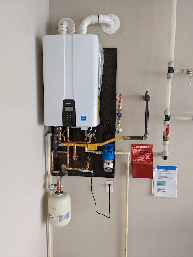 Professional plumber installing copper piping in a Sherwood home